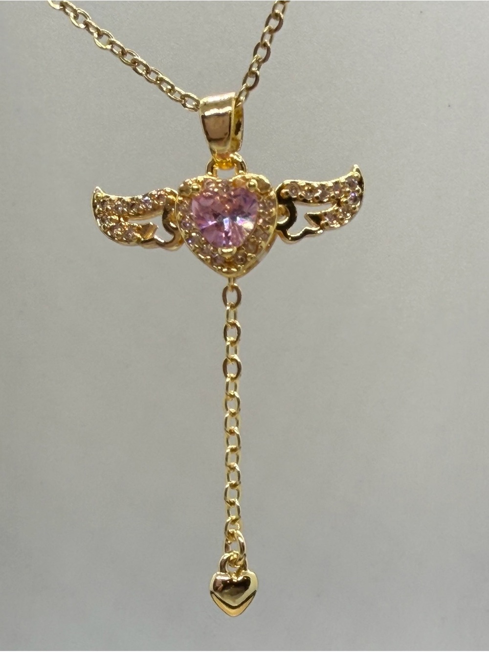 Movable Gold-Tone Winged Heart Pendant Necklace with Pink Crystal